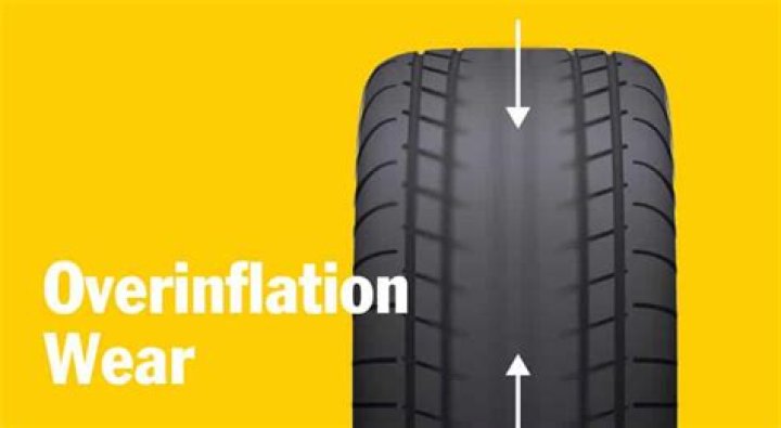 Where does an overinflated tire show its wear?