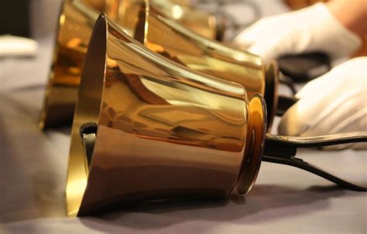 Why do handbell ringers wear gloves?